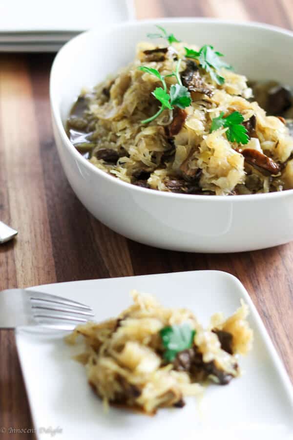 Kapusta - sauerkraut with mushrooms on a plate an in a bowl
