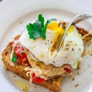 Poached Egg on Parmesan Toast is an amazing breakfast option. Soft runny egg yolk on the tomatoes and herbs with almost crusty parmesan topping makes for irresistible perfect breakfast bite.
