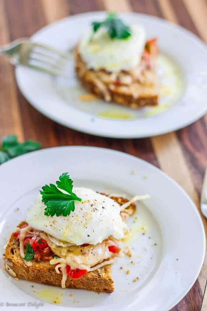 Poached Egg on Parmesan Tomato Toast is a delightful breakfast option. Runny egg yolk infuses with the tomatoes and herbs, and is beautifully balanced by a crusty parmesan topping - making for an irresistibly perfect breakfast bite.