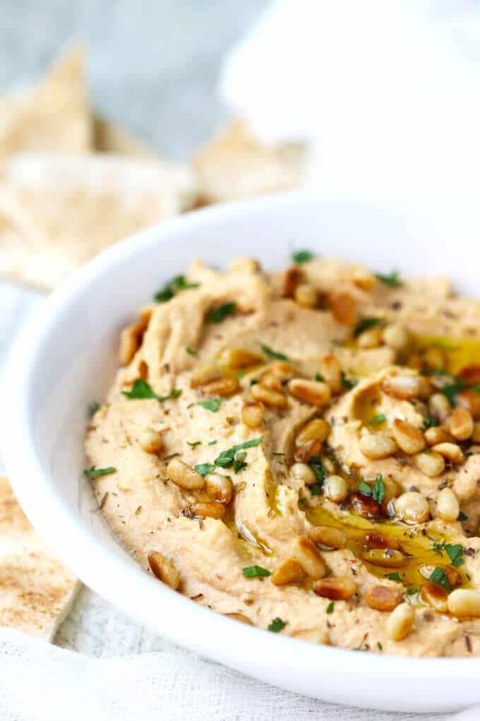Chipotle Hummus with Roasted Pine Nuts is very simple and delicious with a hint of smokiness from spicy chipotles and nice crunch from roasted pine nuts.