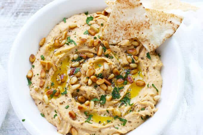 Chipotle Hummus with Roasted Pine Nuts is very simple and delicious with a hint of smokiness from spicy chipotles and nice crunch from roasted pine nuts.