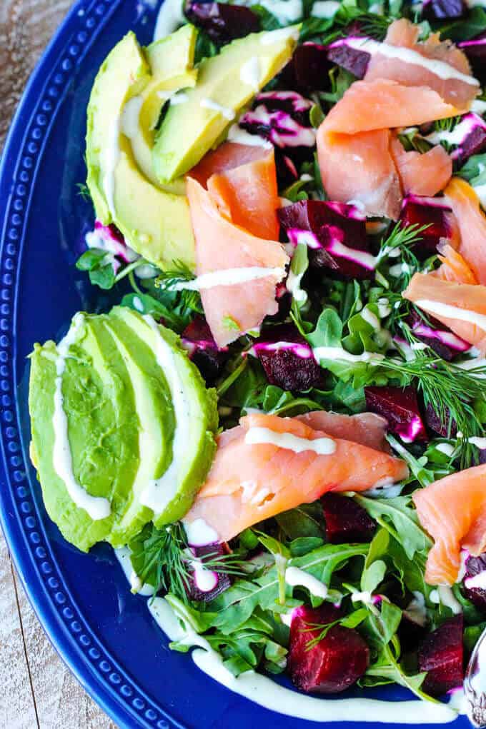 Smoked Salmon and Roasted Beets Salad with a Goat Cheese Dressing with avocado. vertical close up