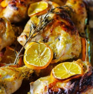 Dijon chicken with lemons in glass baking dish