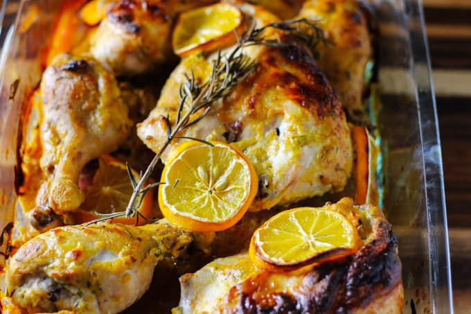 Dijon chicken with lemons in glass baking dish