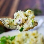 Potato Salad with eggs and pickles on a fork