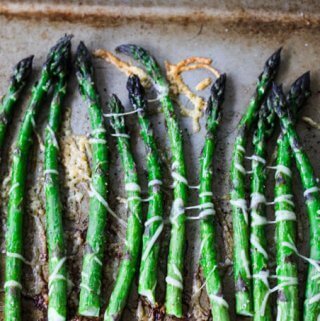 Roasted asparagus with Parmesan Cheese on a sheet pan, vertical photo