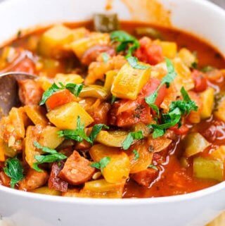 Tomato and Peppers Stew in a bowl with spoon