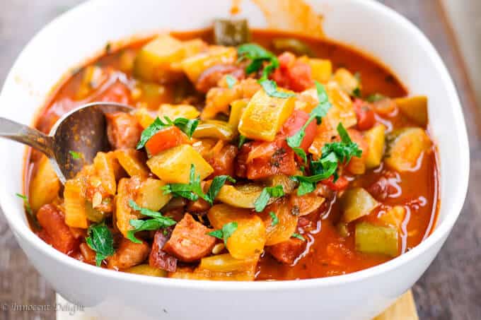 Tomato and Peppers Stew in a bowl with spoon