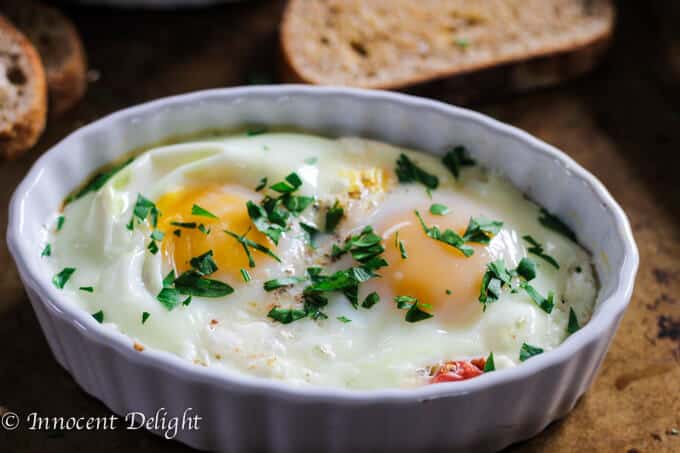 Baked Eggs with Tomatoes and Feta Cheese is a humble breakfast dish with Mediterranean flavors that comes together super quick. 