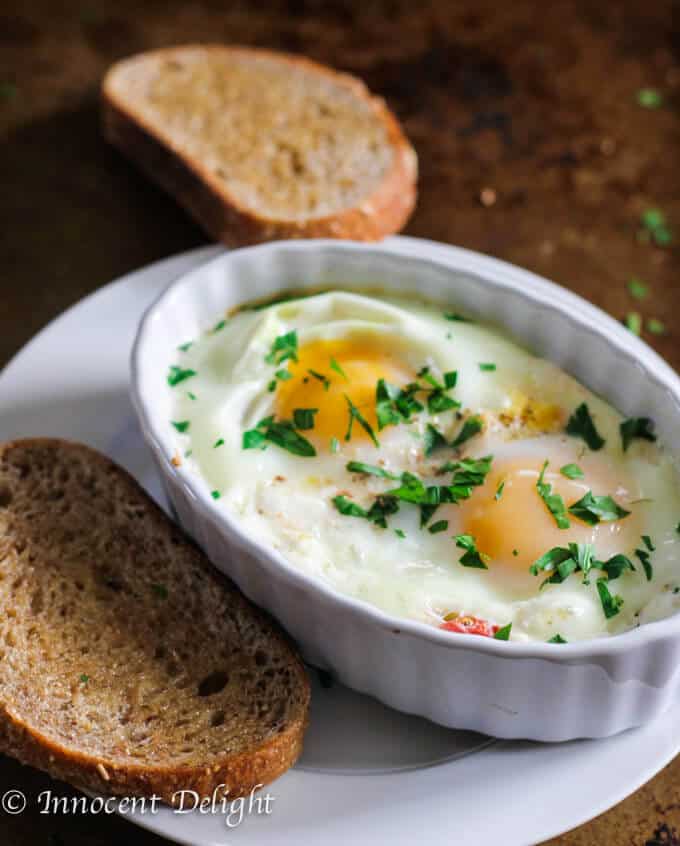 Baked Eggs with Tomatoes and Feta Cheese is a humble breakfast dish with Mediterranean flavors that comes together super quick. 