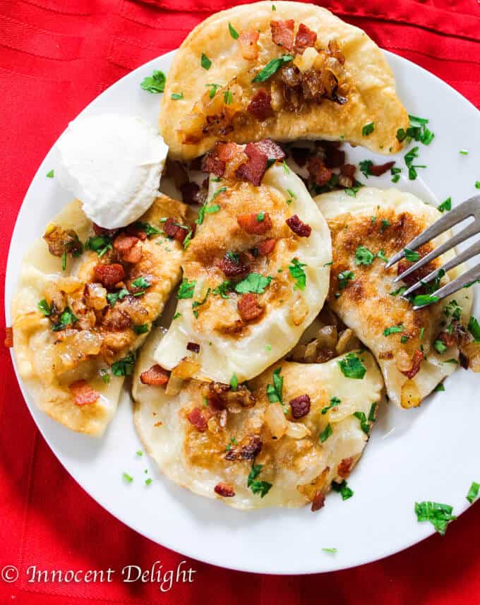 Polish pierogi on a white plate with red napkin