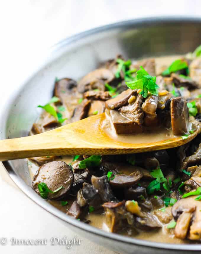 Creamy Mushroom Sauce in skillet with wooden spoon. 