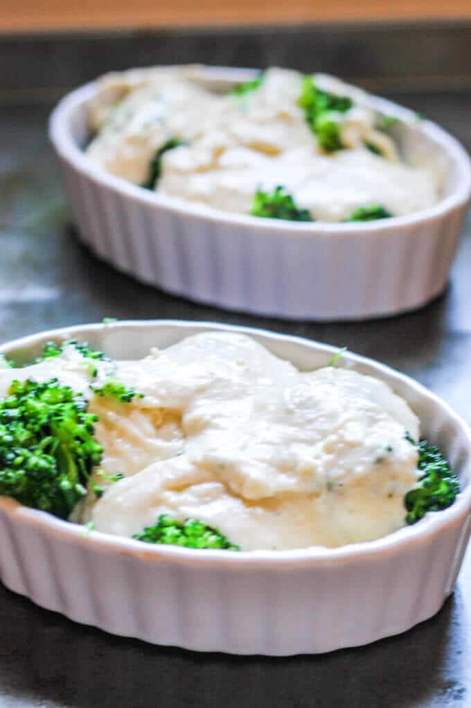 Broccoli in ramekins covered with cheese sauce