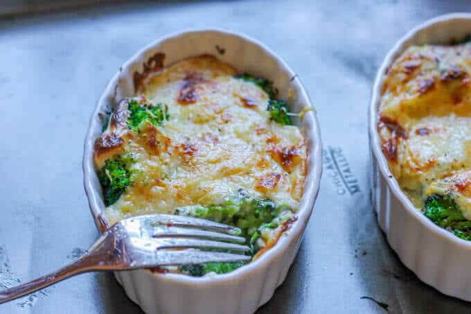 Cheesy Broccoli Au Gratin in ramekins with fork