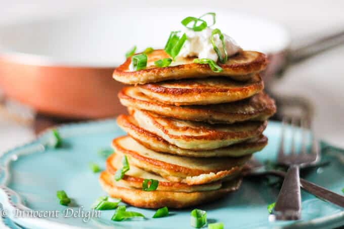 Stock of German or Polish Potato Pancakes on a blue plate with forks