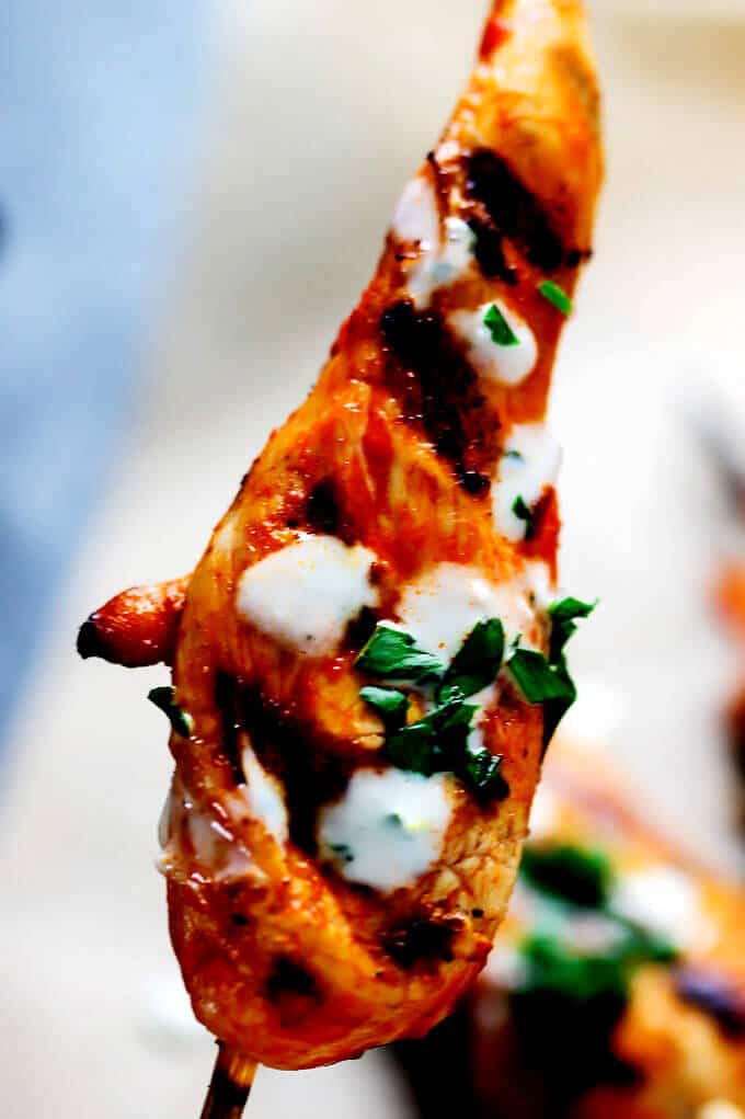 Honey Harrisa Chicken Skewers with Garlic Mint Sauce - amazing combination of Mediterranean flavors in these super tasty skewers with a dollops of refreshing garlic mint sauce. My guests couldn't get enough.