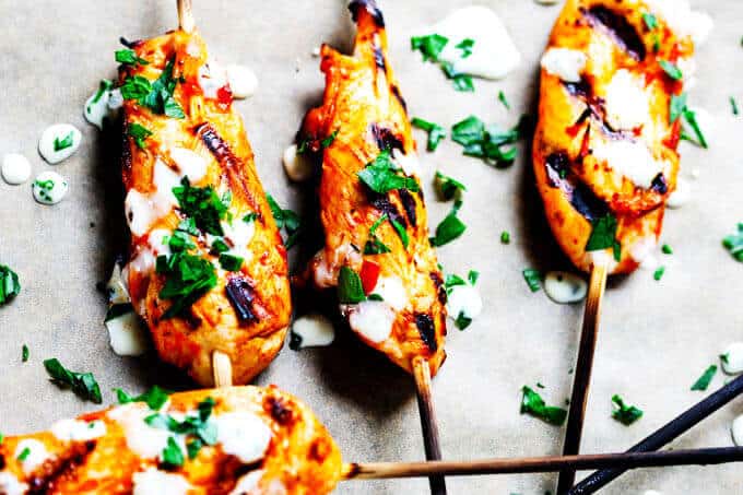 Honey Harrisa Chicken Skewers with Garlic Mint Sauce - amazing combination of Mediterranean flavors in these super tasty skewers with a dollops of refreshing garlic mint sauce. My guests couldn't get enough.