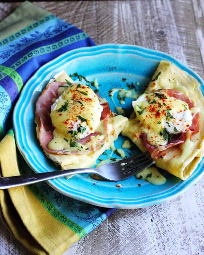 Easy Crepes Eggs Benedict Recipe - super easy twist on this classic American breakfast. Next time you feel like Eggs Benedict, try to pair them with classic French crepes. We couldn't get enough. 