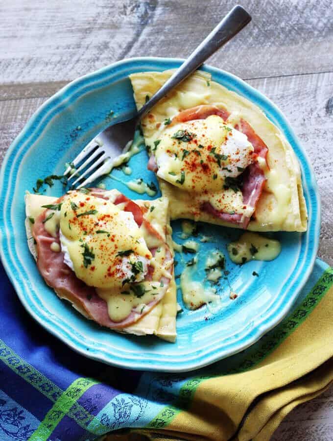 Easy Crepes Eggs Benedict Recipe - super easy twist on this classic American breakfast. Next time you feel like Eggs Benedict, try to pair them with classic French crepes. We couldn't get enough.