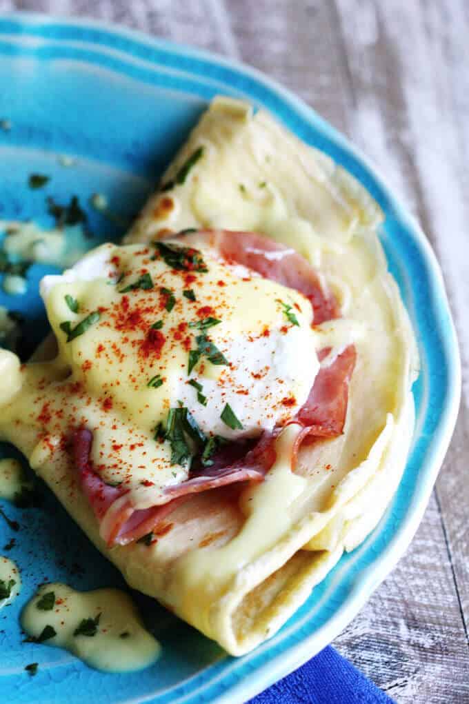 Easy Crepes Eggs Benedict Recipe - super easy twist on this classic American breakfast. Next time you feel like Eggs Benedict, try to pair them with classic French crepes. We couldn't get enough. 