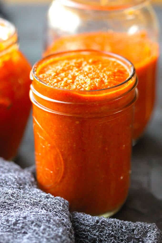 Romesco Sauce in a mason jar (made with peppers, tomatoes, onions, garlic, almonds, bread, olive oil, vinegar and Spanish smoked paprika)