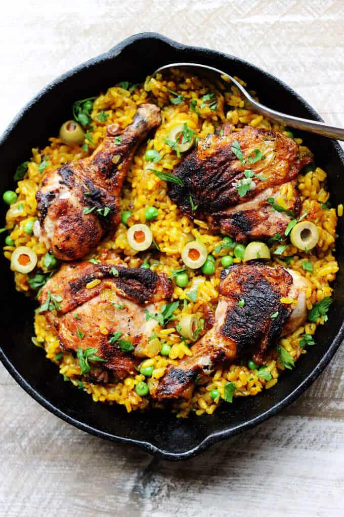One pot chicken saffron rice with saffron, peas, olives and Piementon is an easy weeknight meal that requires minimal work. The oven does the job for you.