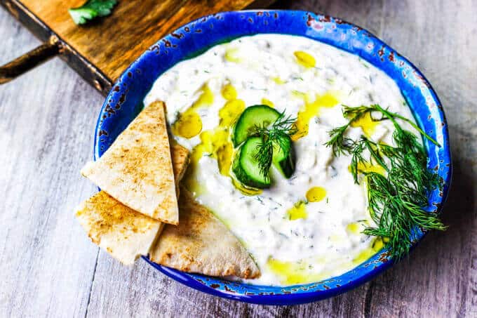 Traditional Greek Tzatziki Recipe combines real thick greek yogurt, seedless cucumber, garlic, dill and splash of vinegar and olive oil. It's a perfect sauce that can be paired with any meals like: grilled meats, vegetables, sandwiches, pitas or salads.