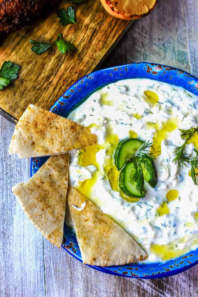 Traditional Greek Tzatziki Recipe combines real thick greek yogurt, seedless cucumber, garlic, dill and splash of vinegar and olive oil. It's a perfect sauce that can be paired with any meals like: grilled meats, vegetables, sandwiches, pitas or salads.