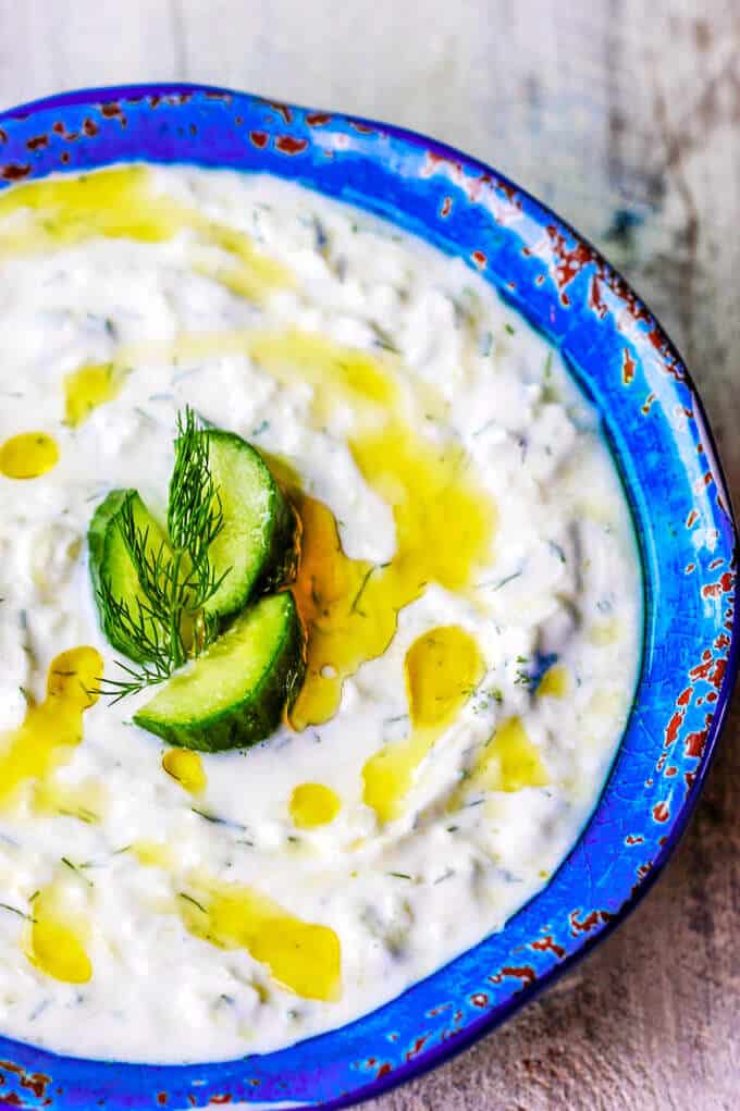 Traditional Greek Tzatziki Recipe combines real thick greek yogurt, seedless cucumber, garlic, dill and splash of vinegar and olive oil. It's a perfect sauce that can be paired with any meals like: grilled meats, vegetables, sandwiches, pitas or salads.