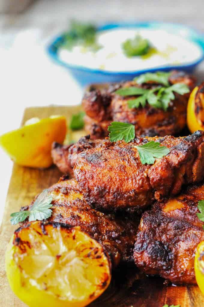 Grilled Chicken Shawarma on a cutting board with grilled lemons