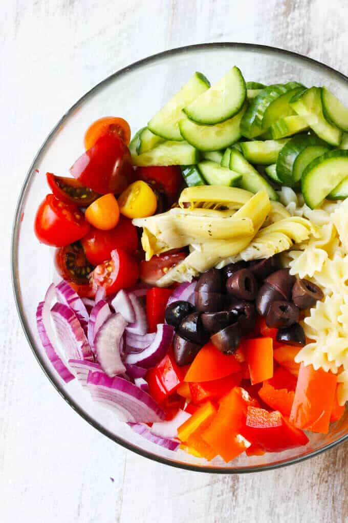 Ingredients for Mediterranean Pasta Salad in a bowl. 