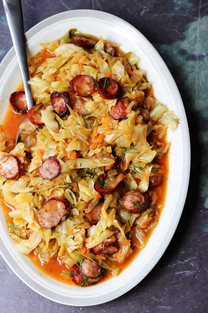 Kielbasa and Cabbage (Hunter's stew) on a serving plate with spoon
