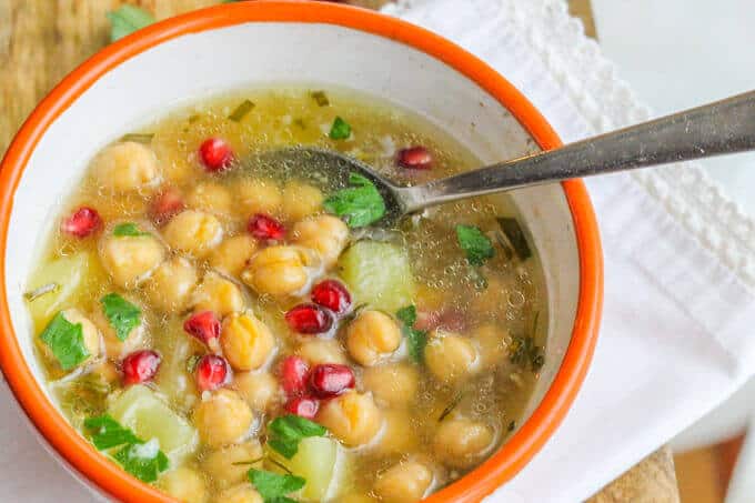 Greek Chickpea Soup (Revithosoupa) with pomegranates in a bowl with spoon