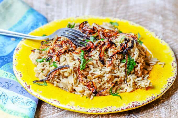 Lebanese Mujadara Recipe combines lentils with rice for a perfect protein meal. Seasoned with Middle Eastern flavors and topped with crispy fried onions makes for a truly irresistible dish.
