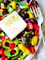 Horiatiki or Greek Salad on a plate with feta and fork