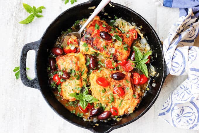 Pan Fried Haddock Mediterranean Style in a frying pan with kitchen towel