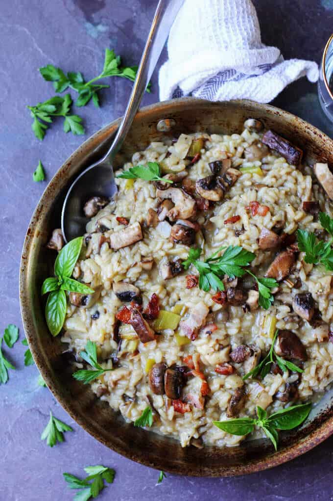 Wild Mushroom Risotto with Bacon and Leeks in a skillet with spoon