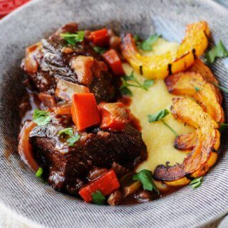 Red Wine Braised Short Ribs with Parmesan Polenta and Roasted Delicata Squash, is a super flavorful dinner idea that will make you feel warm and cozy on a cold, winter night.