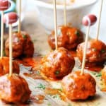 Buffalo Turkey Meatballs with football sticks and bowls with sauces in the back, vertical
