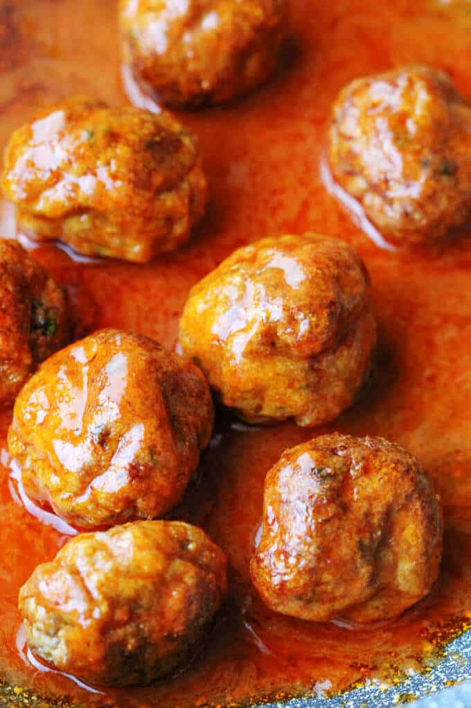 Buffalo Turkey Meatballs in a sauce on a pan