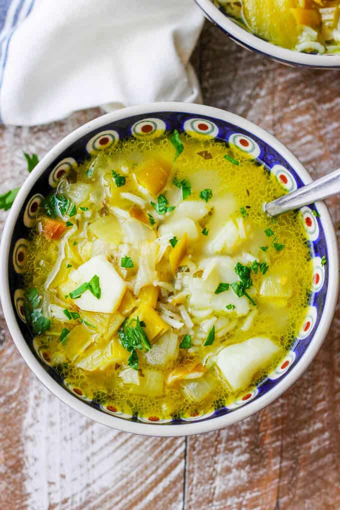 Chunky Potato Leek Soup in a bowl with spoon; overhead shot