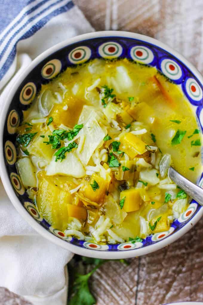 Chunky Potato Leek Soup in a bowl with spoon, overhead shot, close up