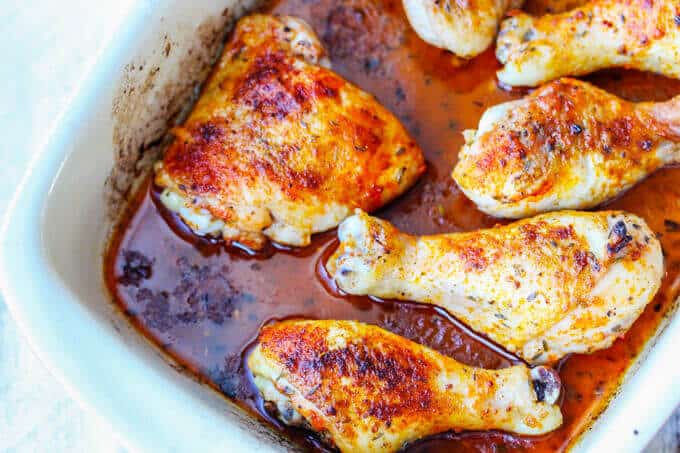 Oven Roasted Chicken Legs in a casserole dish, vertical