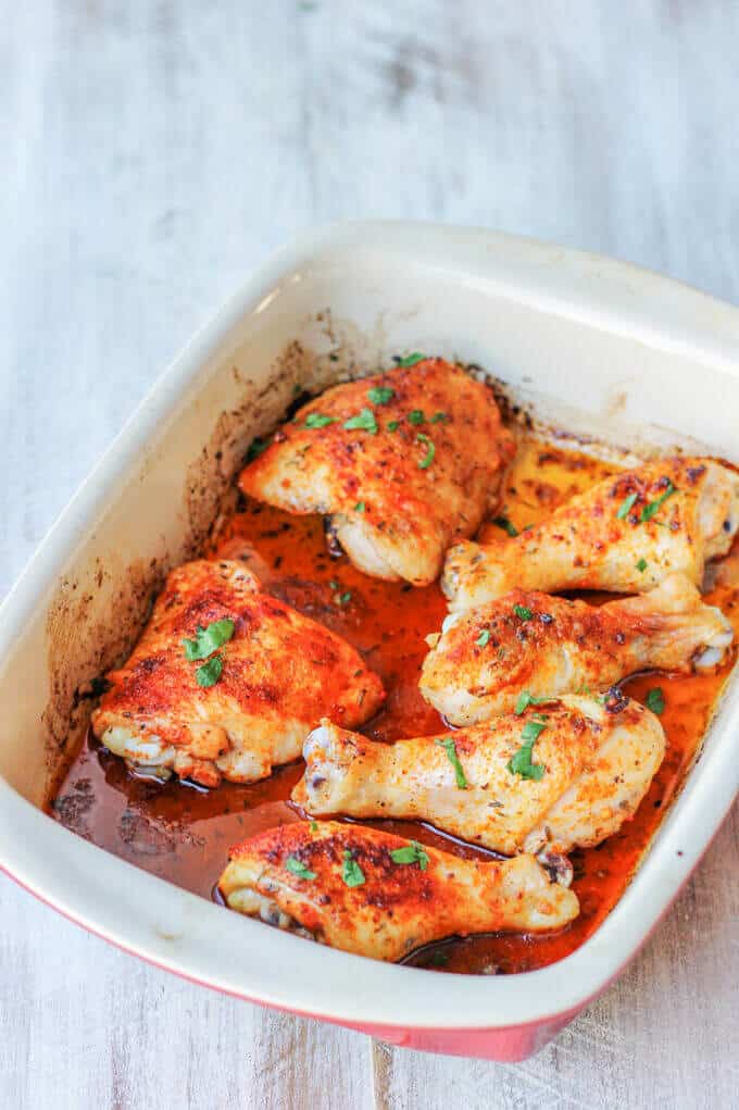 Oven Roasted Chicken Legs in a casserole dish, diagonal, on white board