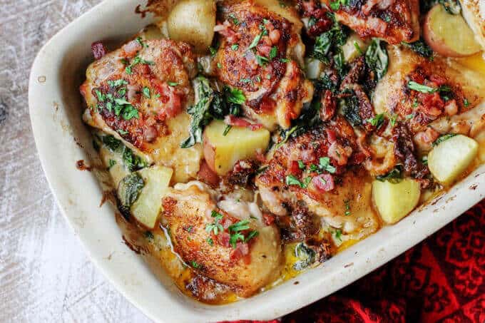 Tuscan chicken and potatoes in casserole dish, horizontal shot