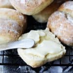 Breakfast rolls with one cut up and with spreader butter