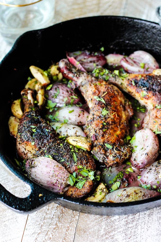 Pan roasted chicken with herbs de Provence in a skillet with shallots and garlic