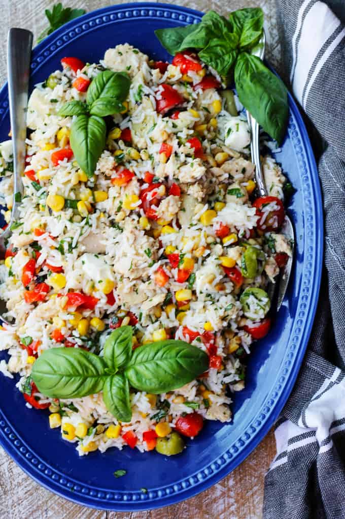 Italian rice tuna salad on a blue plate with kitchen towel on a side