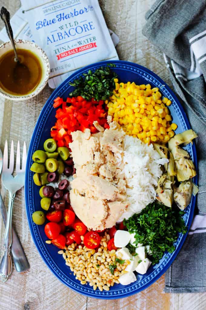 Ingredients for Italian rice salad with tuna on blue plate