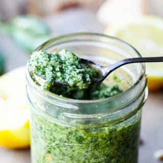 Lemon basil pesto on a spoon with jar